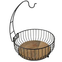 a metal wire basket with wood in it on a white background and an umbrella hook hanging from the side