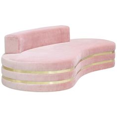 a pink couch with gold trimmings and a curved back rest in the shape of a reclining sofa