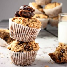 several muffins stacked on top of each other next to a glass of milk