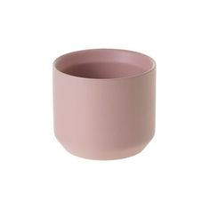 a pink cup sitting on top of a white table