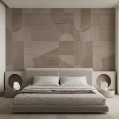 a large bed sitting in the middle of a bedroom next to a wall with geometric shapes on it