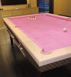 a pink pool table in a living room