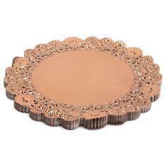 a brown doily with an intricate design on the edge and center, sitting on a white surface