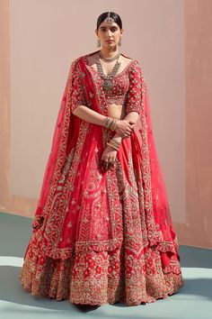 a woman in a red and gold bridal gown