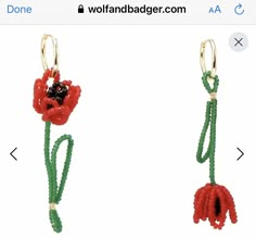 two red and green flowers are attached to the same pair of earrings, one with black beads