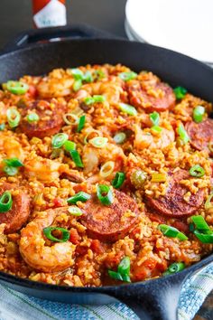 a skillet filled with shrimp and rice