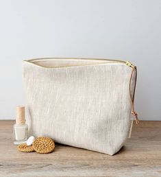 Hello!         Are you looking for a very unique handmade gift for women? ( or for yourself ! )  If yes, this is THE ONE !         This feminine linen pouch  is made in a beautiful  natural linen / cotton canva.  It will become her favorite makeup bag to carry her little needs ; cosmetics, makeup, lip balm, beauty products, skin care products, personnal stuff and more. It could be used as a travel pouch too. The neutral solid pattern is loved from every taste -Earthy and Casual Style-  it fits every women.  Carefully handcrafted, High quality fabric at  a good price.  Win-Win !  For you, Who is this Special woman who will be happy to receive it? Your grilfriend, mother, wife, sister, niece ? About your mother-in-law ? ( she will be impressed for sure ;)) You choose. SPEC: . Handmade by Cou Beige Makeup, Tampax Pearl, Linen Pouch, Toiletry Bag Women, Canvas Bag Design, Large Makeup Bag, Pouch Makeup, Favorite Makeup, Unique Gifts For Women