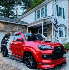 a red truck parked in front of a house