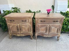 two wooden dressers sitting next to each other on top of a cement ground with plants in the background