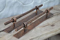 an old wooden bench with some metal handles on it