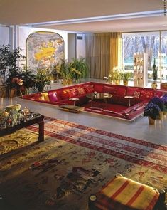 a living room filled with lots of red couches