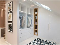 a white closet with lots of clothes hanging on the wall and pictures on the wall