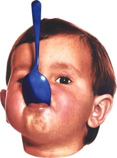 a child with a blue spoon sticking out of his nose