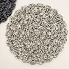 two crocheted placemats sitting next to each other