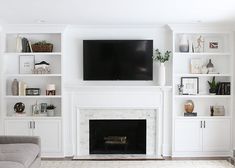 a living room filled with furniture and a flat screen tv mounted on the wall above a fireplace