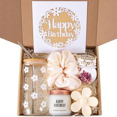 a birthday gift box with candles, cookies and condiments