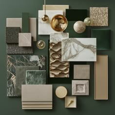 an assortment of different colored and textured materials on a green surface with gold accents