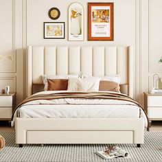 a bedroom with white furniture and pictures on the wall