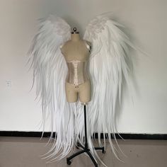 a mannequin with white feathers on top of it