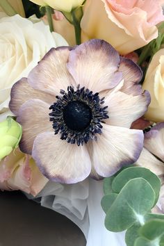 an assortment of flowers are arranged in a vase