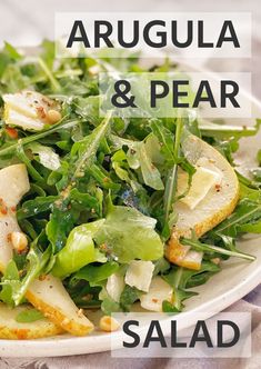 a salad with arugula and pears in it is on a white plate