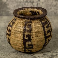 a brown and black basket sitting on top of a table