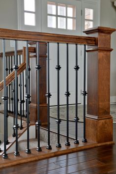 a wooden stair case with metal handrails in a home's entryway