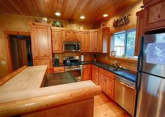 a kitchen with wooden cabinets and stainless steel appliances