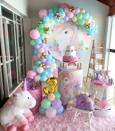 a unicorn themed birthday party with balloons and decorations