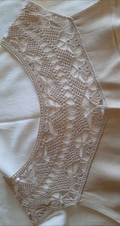 an image of a piece of cloth with crocheted lace on the top and bottom