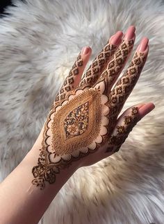 a woman's hand with hennap on it, showing the intricate design