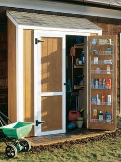 a storage shed with the door open and shelves full of items on it's side