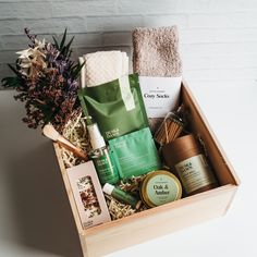 a wooden box filled with items from the body and hand care line on top of a white table