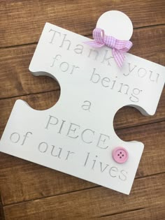 a puzzle piece with a pink bow on it