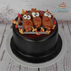 a cake decorated with three cartoon characters on top of it