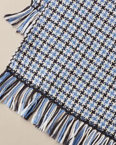 a blue and black plaid scarf with fringes