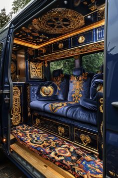 the interior of a blue van with intricately painted furniture on it's sides