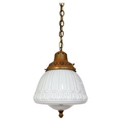 an old fashioned light hanging from a chain