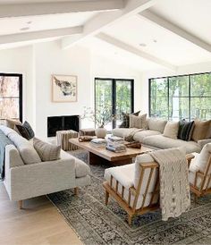 a living room filled with furniture and windows