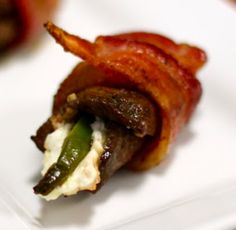 bacon wrapped in cheese and green peppers on a white plate