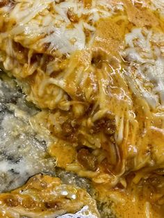 a close up view of some food with cheese and sauce on the top, as if it were lasagna