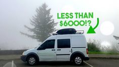 a white van parked in a parking lot next to a sign that says less than $ 6000