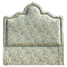 an upholstered headboard with blue and green flowers on it