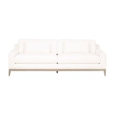 a white couch sitting on top of a wooden table