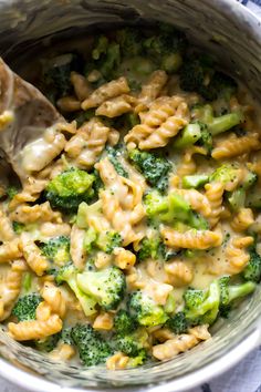 broccoli macaroni and cheese casserole with a spoon in it