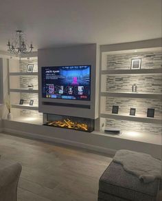 a living room filled with furniture and a flat screen tv mounted on a wall above a fireplace