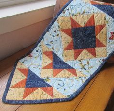 a quilted tie sitting on top of a window sill next to a window