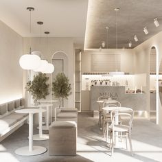 an empty restaurant with white tables and chairs