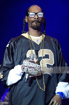 rapper snoop blac holding an award on stage