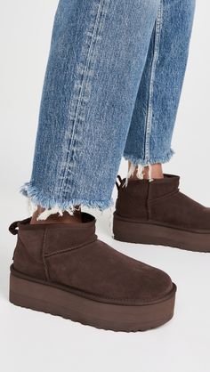 Find UGG Classic Ultra Mini Platform Boots on Editorialist. Cannot be shipped outside the USA Upper: Cowhide suede. Lining: Sherpa. No closure, pull-on design. Round toe. EVA sole. Imported, Vietnam. This item cannot be gift-boxed. Measurements: Platform: 2.25in / 60mm Ugg Classic Ultra Mini Platform, Ugg Ultra Mini Platform, Brown Ugg Boots, Ugg Snow Boots, Ugg Boots Outfit, Ugg Ultra Mini, Soft Gloves, Ugg Classic Ultra Mini, Brown Outfit